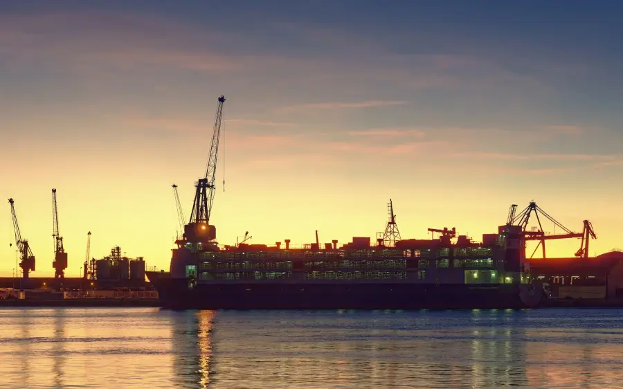 Livestock carrier in port at sunrise